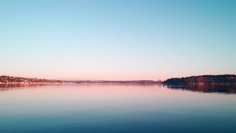 lake washington calm water and mountain view at sunrise