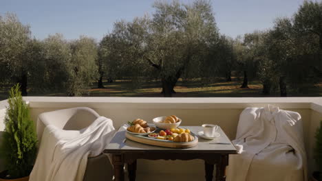 breakfast on a balcony overlooking an olive grove