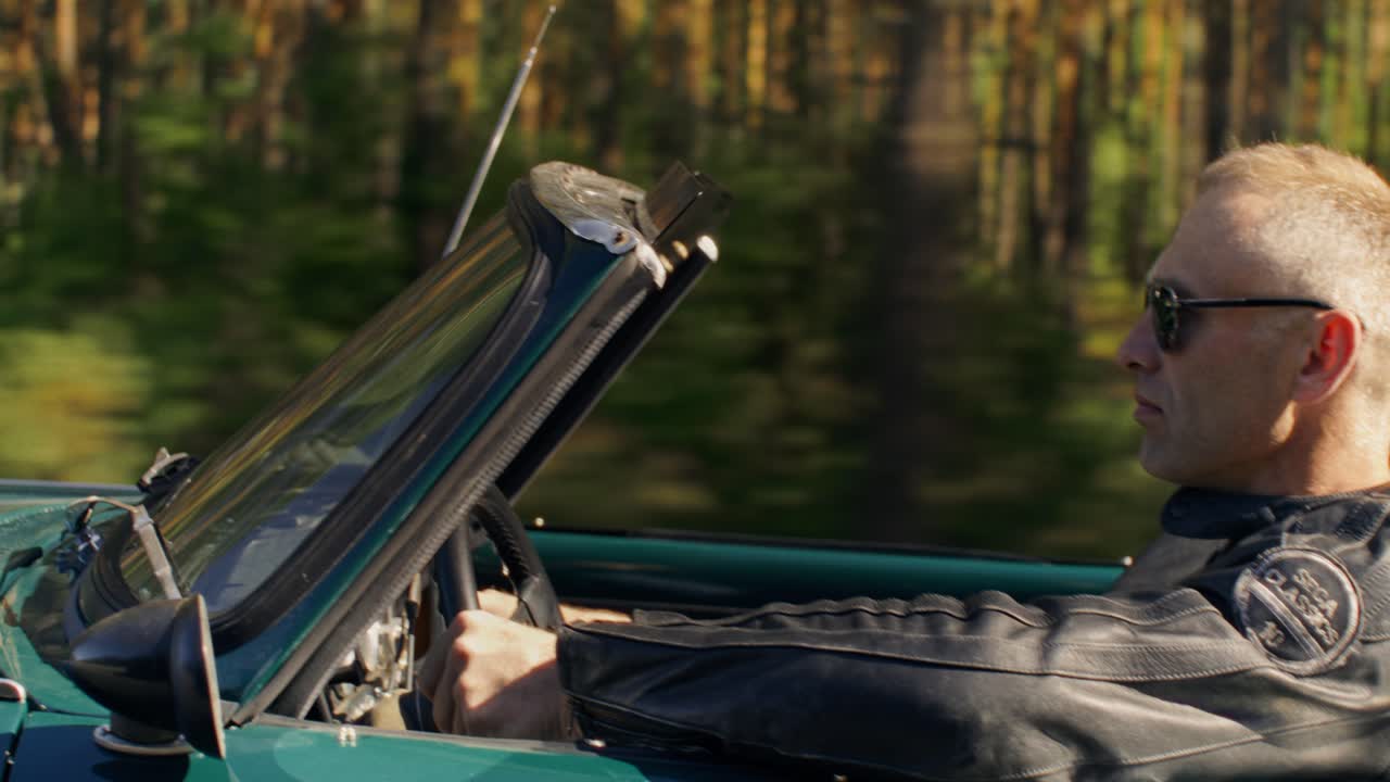 Man Driving a Classic Convertible