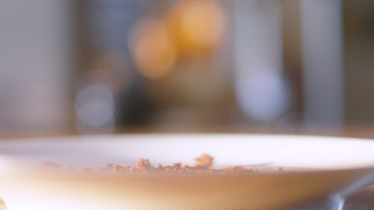 Fork Gently Picking Up Piece of Milk Chocolate Fudge Cake Dessert with Shallow DOF. Eating with Cutlery. Served at Birthday Parties or Afternoon Tea. Food Photography.