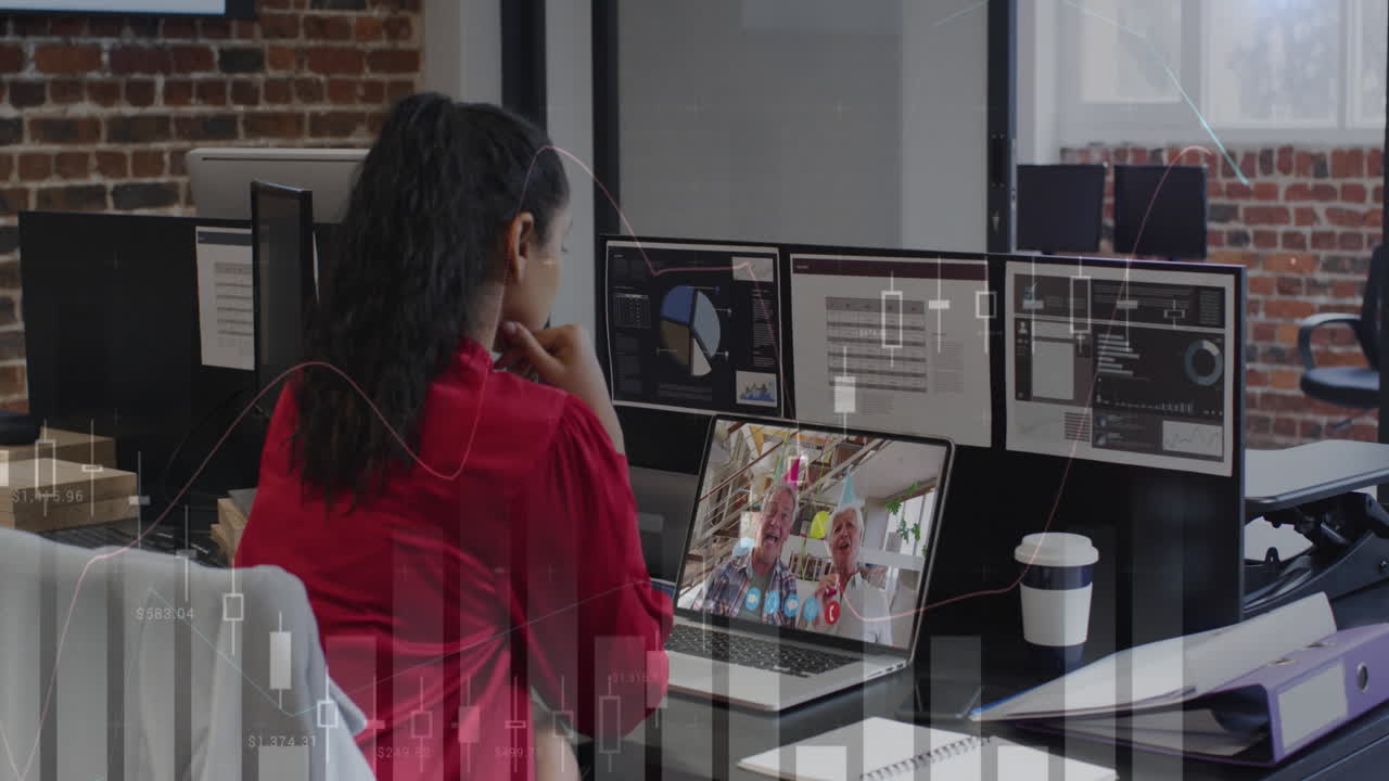 Animation of data processing over rear view of biracial woman having videocall on laptop at office