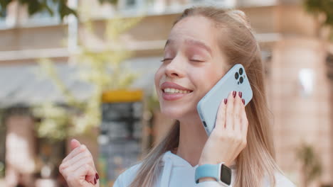 caucasian woman tourist having remote conversation communicate speaking by smartphone on city street