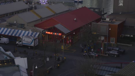 panoramic shot of a barely empty city public market at dusk where few people are doing their daily business