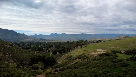 rising drone shot capturing the scenic beauty of clarens, free state, with rolling hills and greenery. perfect for nature, travel, and adventure projects