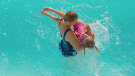 Mother-playfully-lifts-spinning-daughter