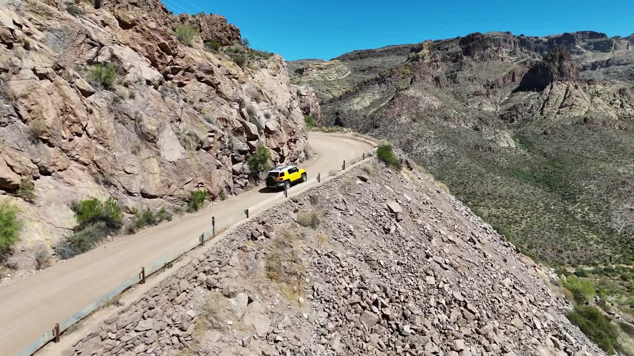 Yellow Truck Driving on Edge of a Mountain Road. Fish Creek Hill on the Apache Trail in Arizona