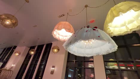 panning shot of hanging petticoat light fixtures in the graduate hotel at nashville, tennessee.
