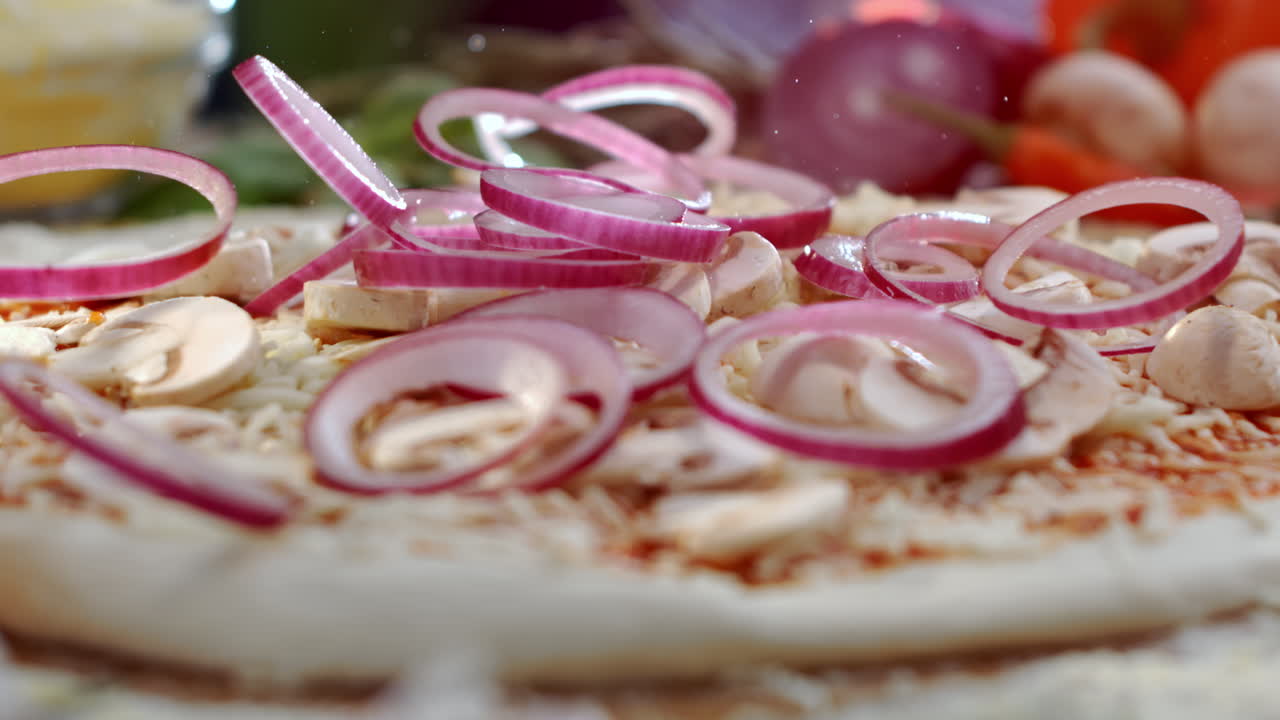 Making pizza with onions and mushrooms