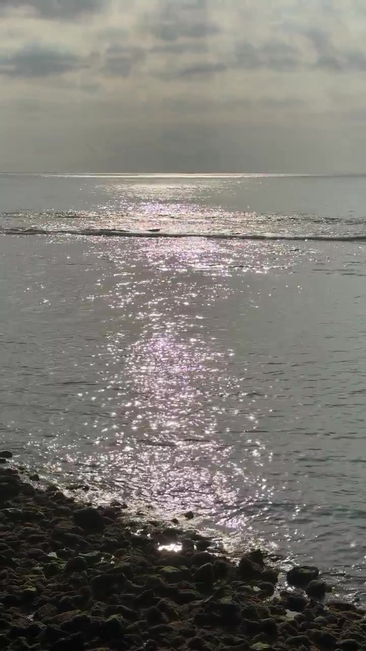 Sunlight Reflecting on Calm Ocean Waves at Sunset