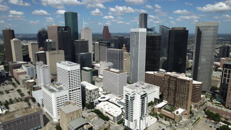 aerial tracking shot in front of the city center of houston, in sunny texas, usa