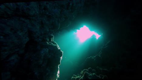 Underwater-lightened-cavern-by-sunshine-above-blue-ocean-depths-diving-experience-at-scuba-diver's-trip-in-egypt-Dahab