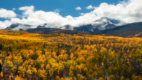 time lapse kebler pass cinematic crested butte gunnison colorado seasons crash early fall aspen tree red yellow orange forest winter first snow cold morning clouds rolling rocky mountain peaks zoom