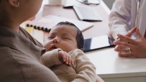 baby and doctor in clinic