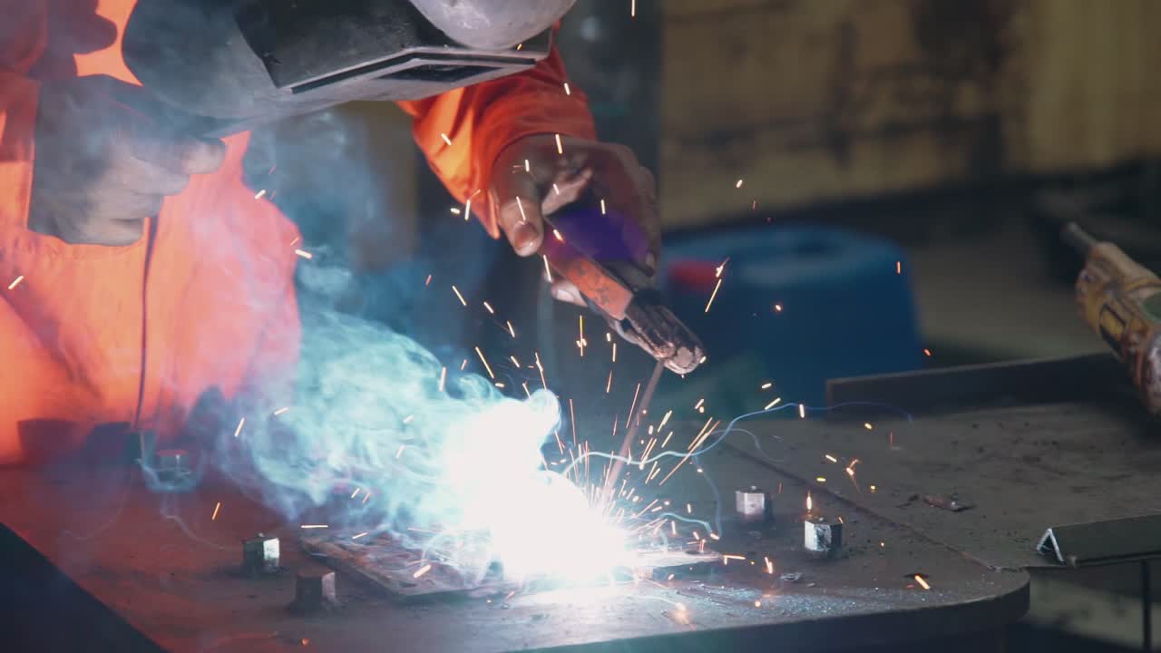 Metal welder working with arc welding machine