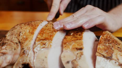 Close-up-on-chef-hands-cutting-fresh-cooked-turkey-meat