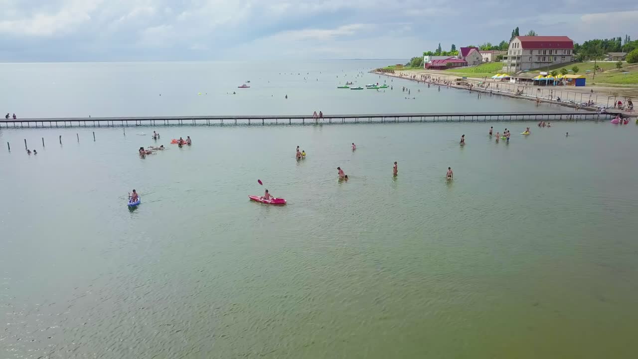HORLY, UKRAINE- JULY 8 2021. People swim on the beach 01