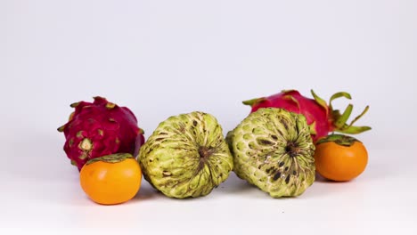 hands selecting various fruits from a table