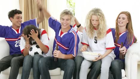 Adolescentes-Viendo-Un-Partido-De-Fútbol-En-Casa.