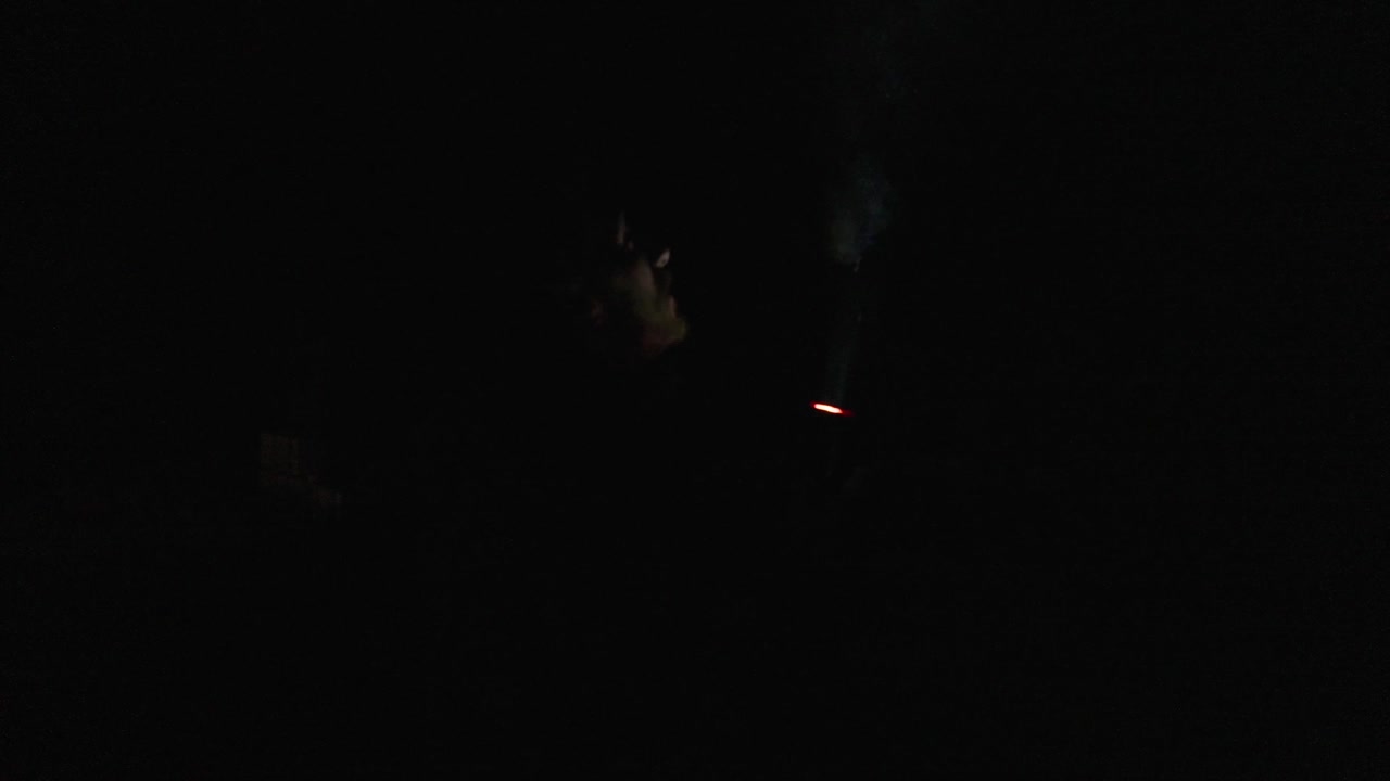 Person with a flashlight in a dark area