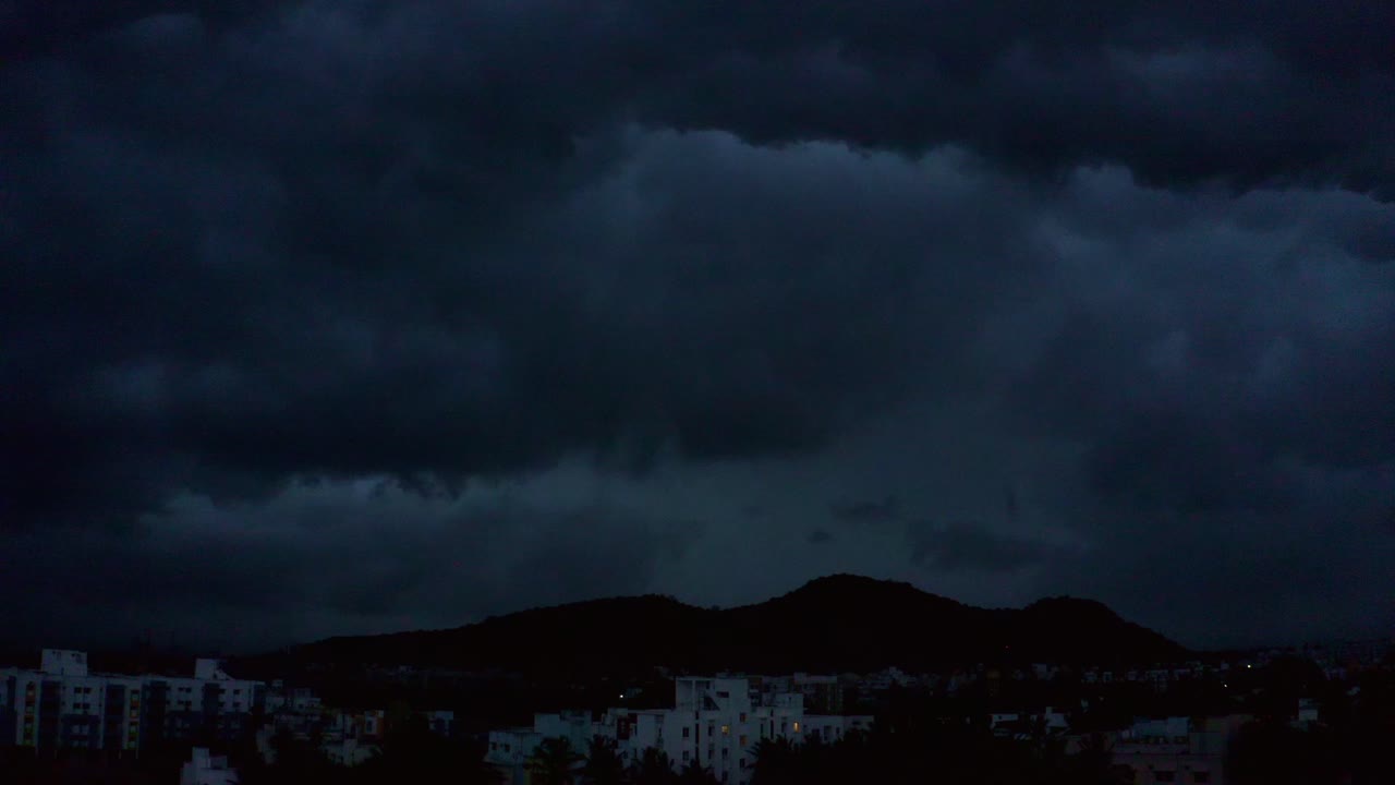 Dark Storm Clouds Over City at Night