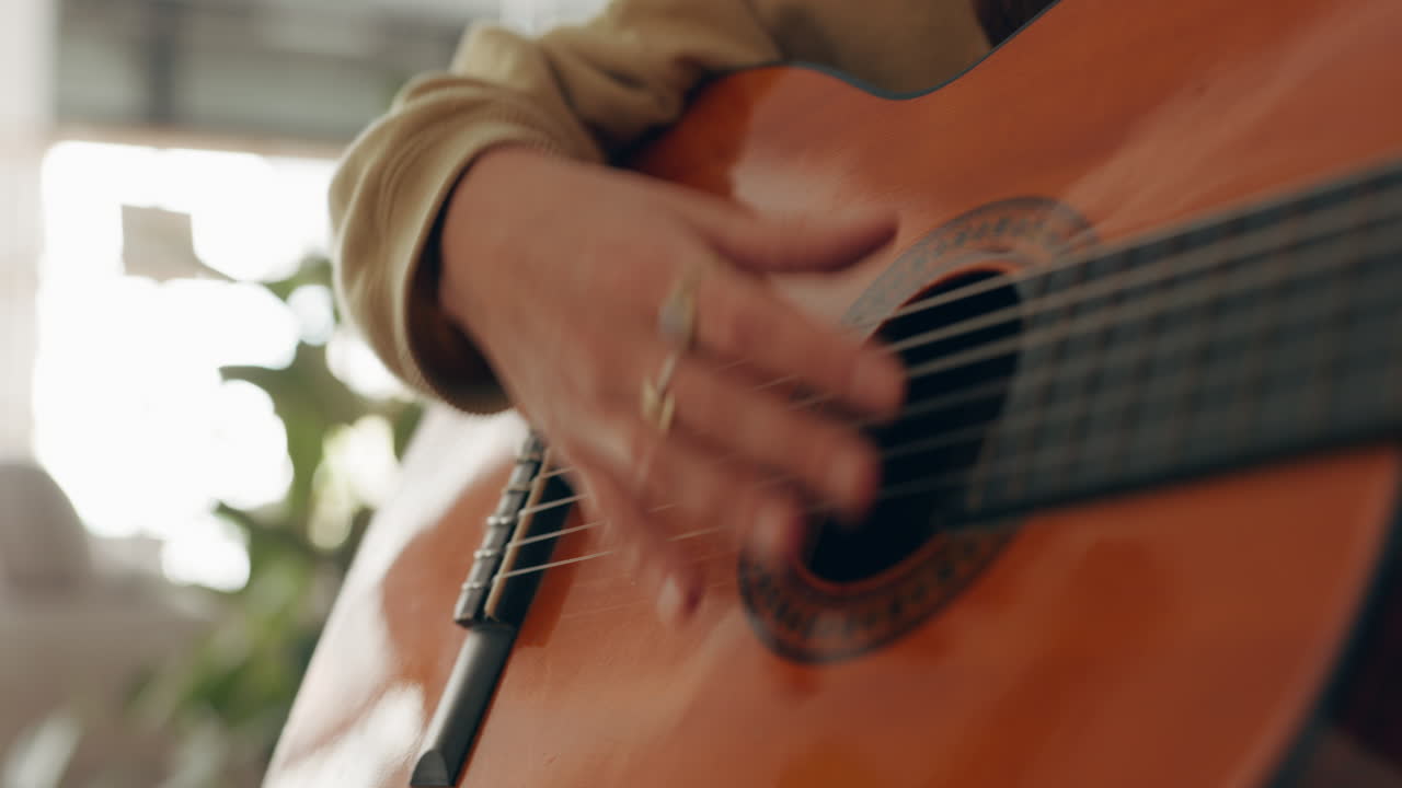Hands, music and guitar by woman artist playing