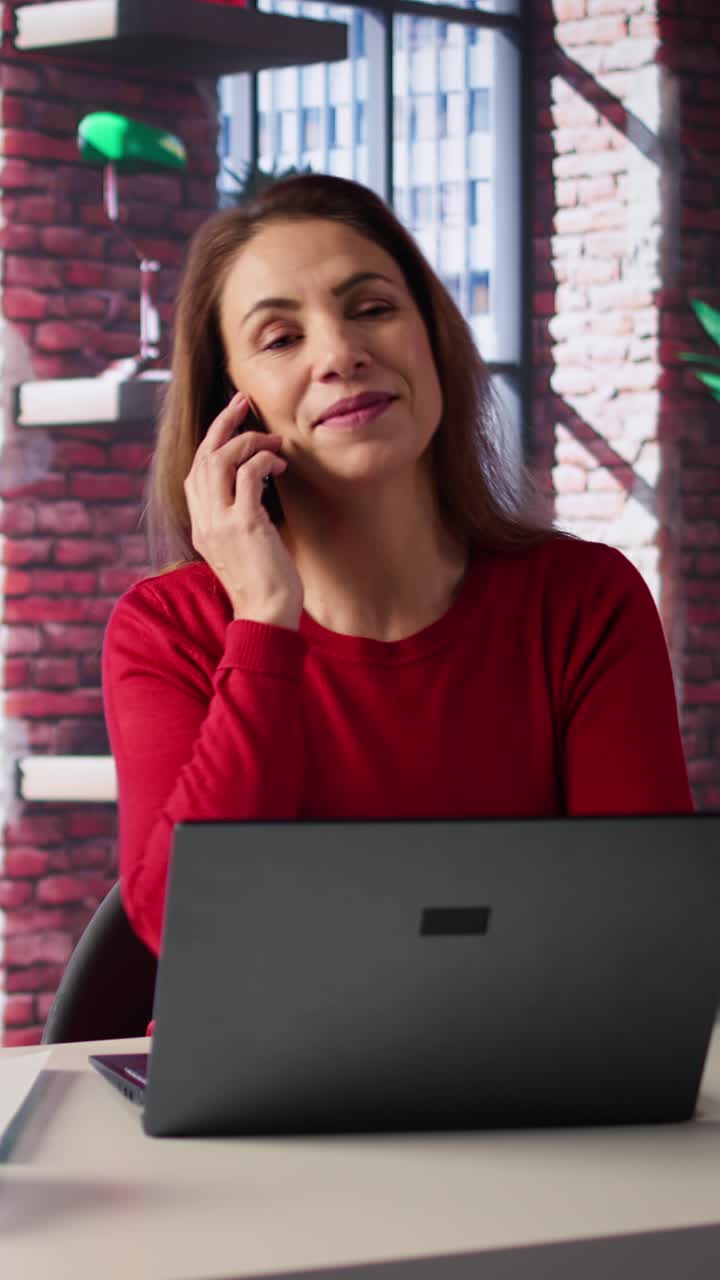 Vertical Video Mature woman dialing a phone number to make inquiries about productivity