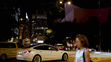 cars and pedestrians navigate a busy intersection