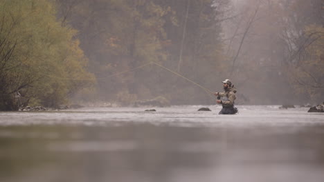 fly fishing in a misty autumn river