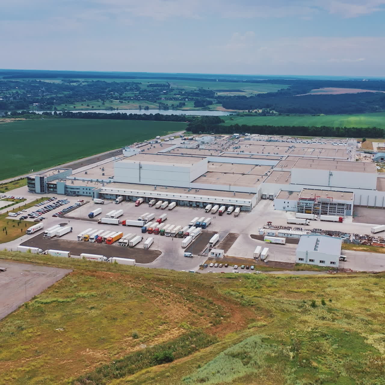 Aerial footage of a large industrial complex. Modern Factory Exterior.