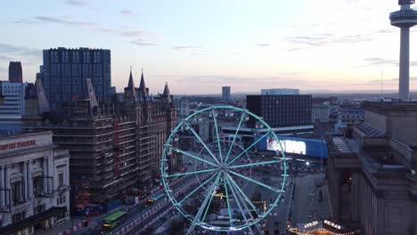 liverpool city christmas market sunset skyline and radio city landmark aerial view tilt down to ferris wheel attraction