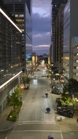 vertical drone shot flying along the texas avenue in houston city, dusk in usa