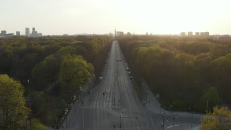 AERIAL:-Strasse-des-17.-Juni-in-Berlin,-Germany-towards-Victory-Column-Empty-because-of-Coronavirus-COVID-19-Pandemic-in-Beautiful-Sunset-Light