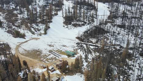 aerial camera pans down to show a ski lodge damaged in a wildfire