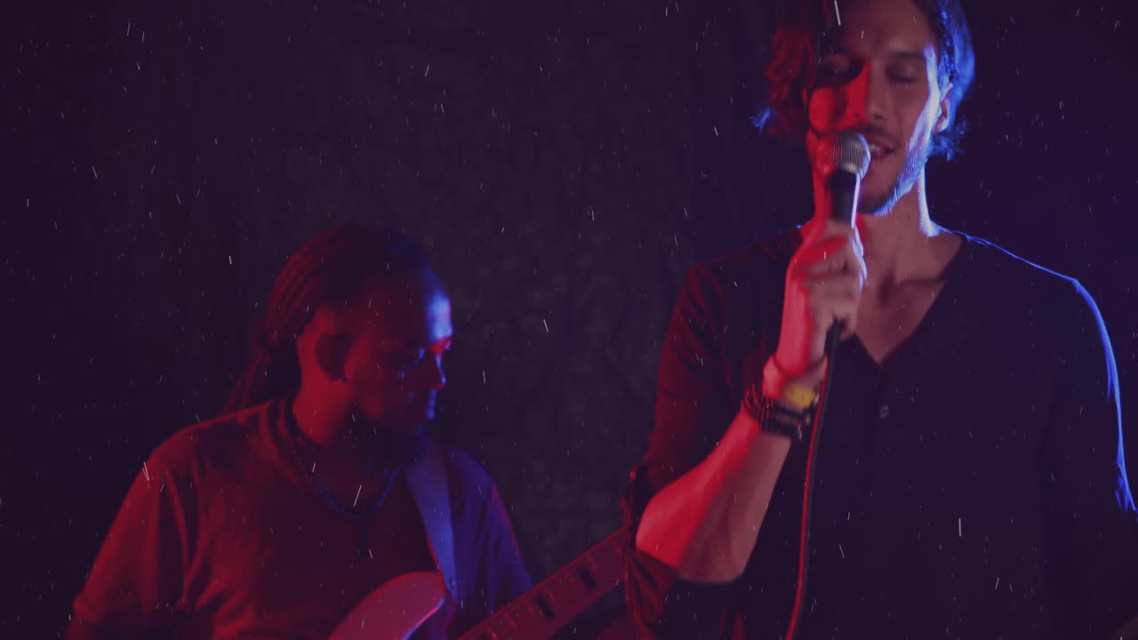 two male musicians performing on concert stage, with animated rain and colored lighting overlays