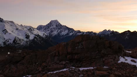 Panorama-view-of-golden-sunset-behind-snowy-mountains-at-Mueller-Hut-Route,NZ