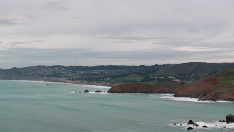 Drone-aerial-shot-of-waves-crashing-up-on-rocky-peninsulas-and-California