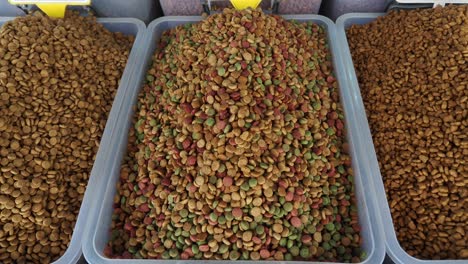 closeup of three bins of dry dog food