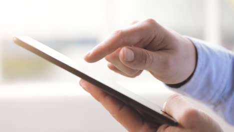 man-hand-touching-tablet-computer-surface-touchscreen-pad