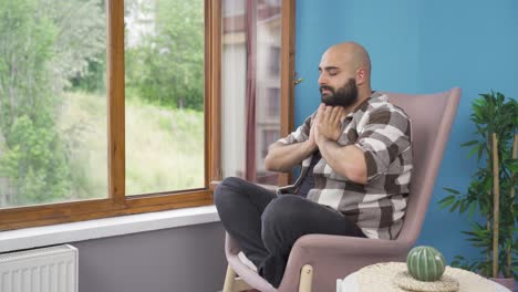 Man-doing-yoga-outside-in-front-of-the-window.