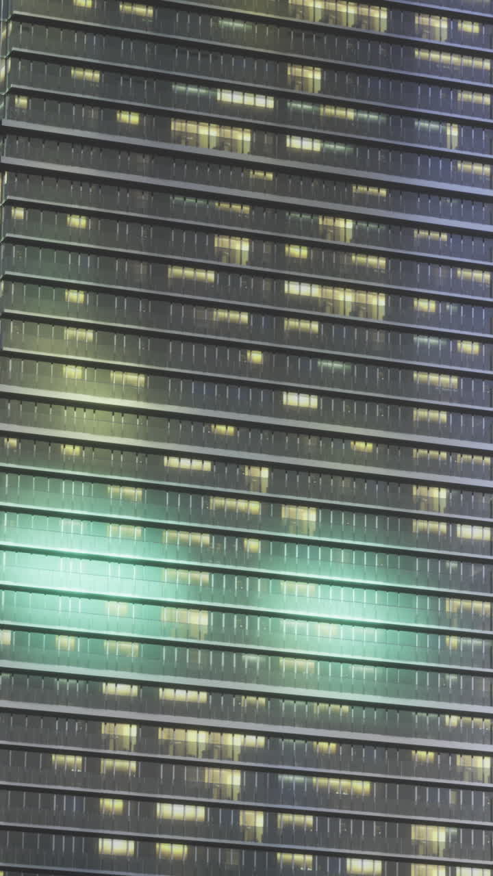 City skyline at night with illuminated windows in a modern skyscraper