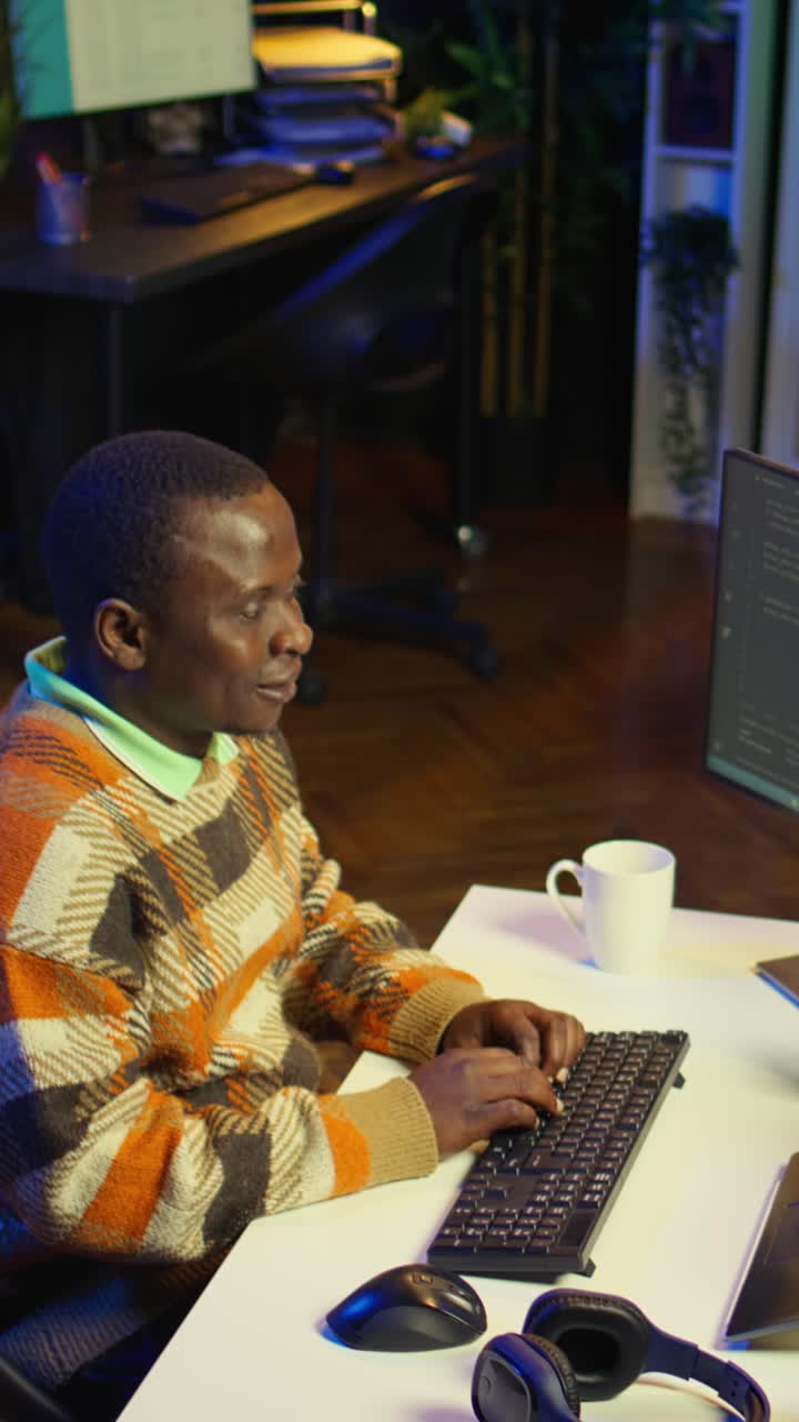Vertical Video African american man working on computer to write code and programming