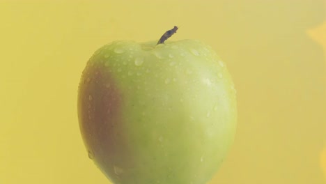 ripe fresh apple lie on a yellow background. 4k video