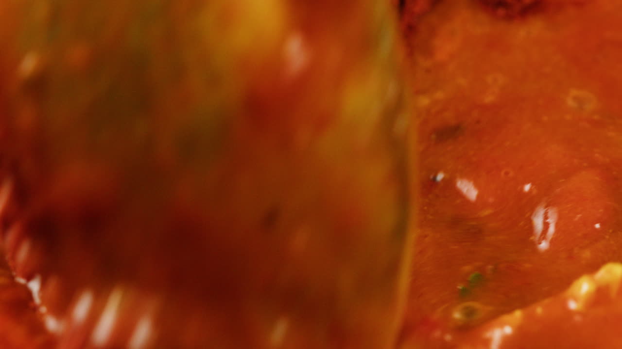 Chicken in tomato sauce is boiling on a frying pan with spices. Cooking tomato sauce curry with chicken fillet. Traditional Italian Mexican Asian dish. High quality studio shot for cafe, restaurant close up.