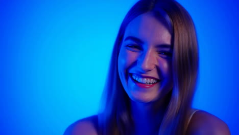 smiling young woman with blue background