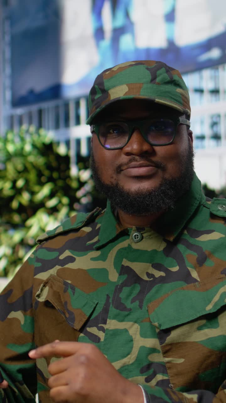 Vertical Video Professional adult soldier in uniform checking his smartphone apps on sidewalk