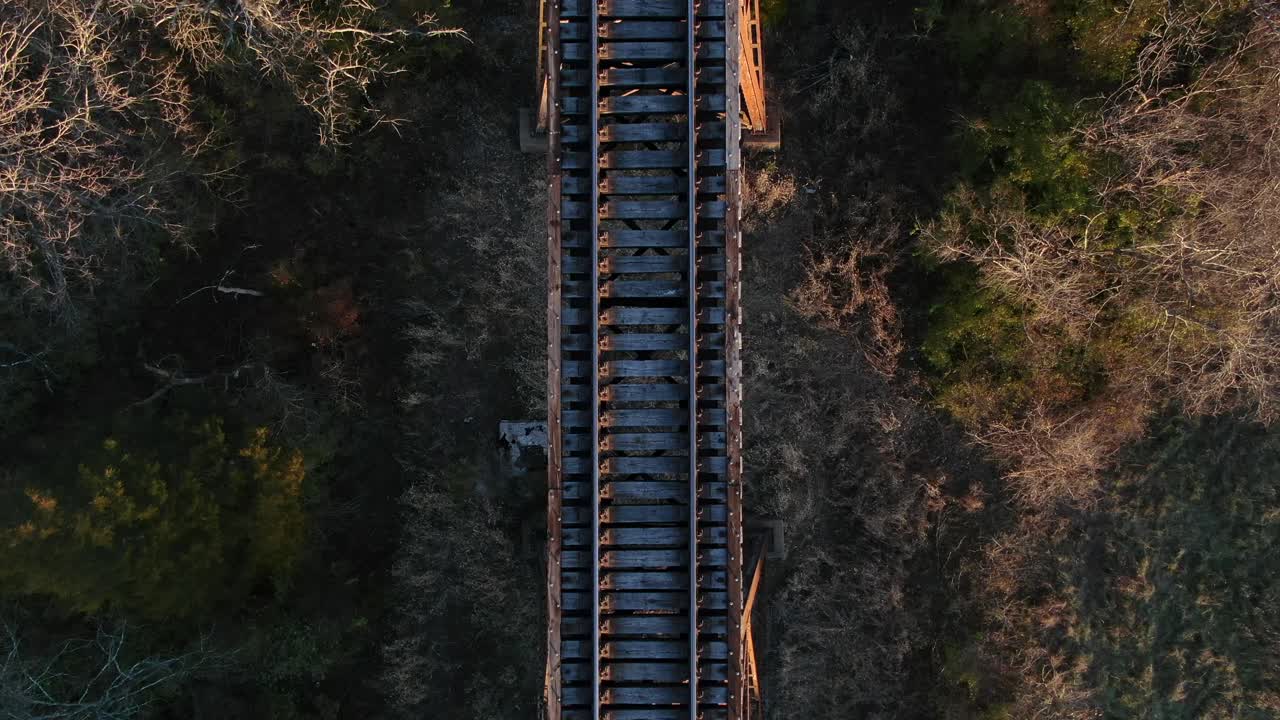 Aerial Top Down Shot Moving Along the Tracks of the Pope Lick Railroad Trestle in Louisville Kentucky at Sunset