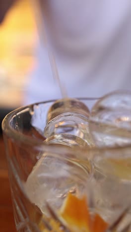 pouring a cocktail with ice