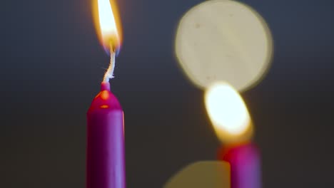 una vela roja se enciende con un encendedor