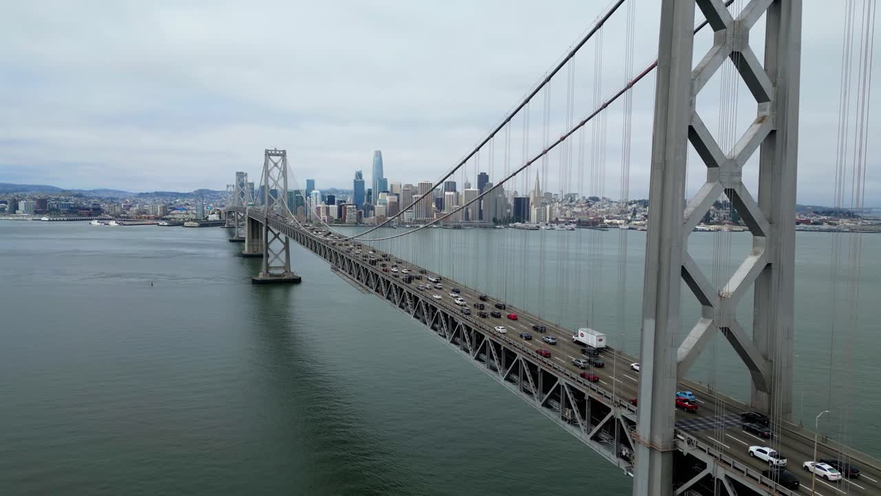 Drone flies forward near Oakland Bay Bridge toward San Francisco skyline (60fps)
