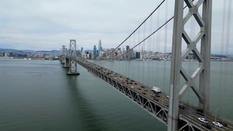 drone flies forward near oakland bay bridge toward san francisco skyline (60fps)